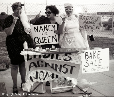 three crossdressing men with protest signs