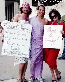 three crossdressing men with protest signs