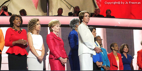 Minority Leader (and former Speaker) Nancy Pelosi stands in front of the House women.