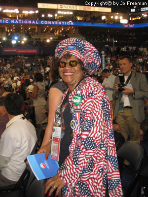 A lady wears an american flag outfit and glasses with donkey motifs