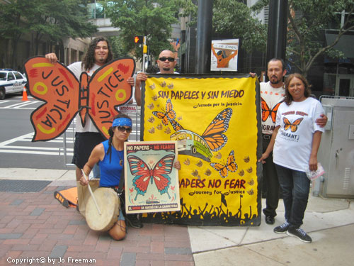 immigrants demonstrate on a sidewalk