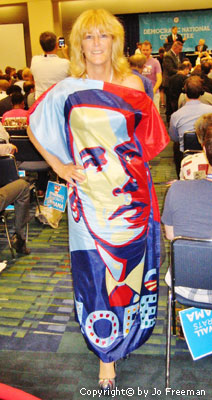A woman wears a dress made from an Obama pop art banner