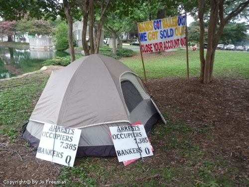 a tent compares the many occupiers arrested to the number of bankers arrested: zero