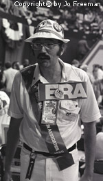 A male deligate wears a National Education Association sash and a large ERA sign
