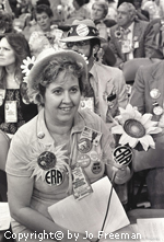 A female deligate is covered in ERA buttons and sunflowers