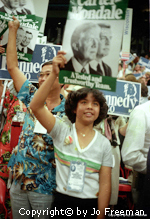 A child holds up a Carter-mondale sign, as does his father.