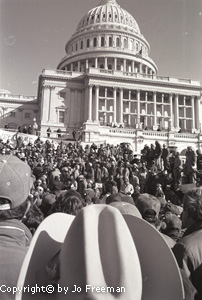 a Crowded scene of Farmers marching up the steps of the US Capitol Building