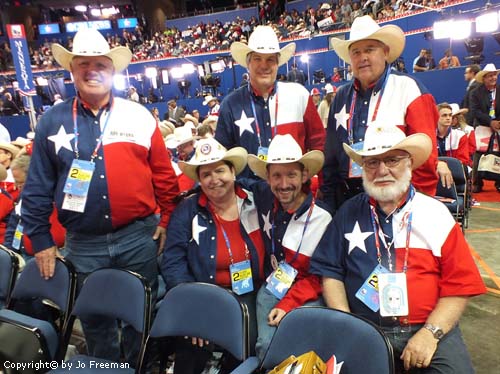 Six texans wearing flag of Texas shirts and cowboy hats