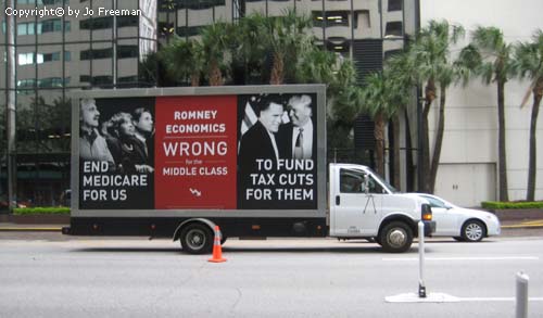 a mobile truck based billboard states Romneys economic plan is wrong