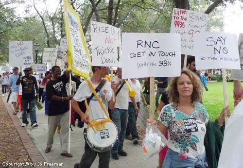 diverse protestors holding signs