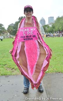 Code Pink Protestor wears large sign