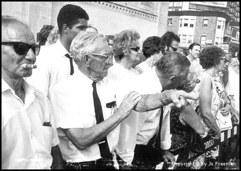 Male spectators respond to the skit.