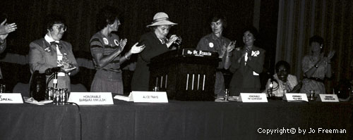 Bella Abzug prepares to speak as others applaud