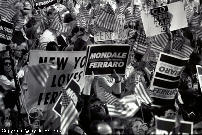 the crowd waves ferraro banners and posters