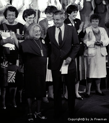 Mondale and Ferraro with a group of women behind them on a stage