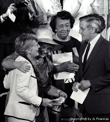 Mondale and Ferraro with a group of women behind them on a stage