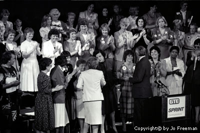 Mondale and Ferraro with a group of women behind them on a stage