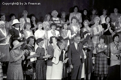 Mondale and Ferraro with a group of women behind them on a stage