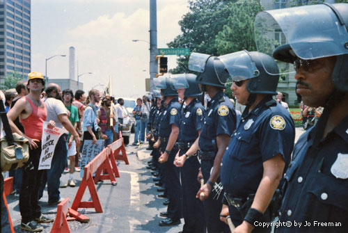 a line of protestors face a line of police