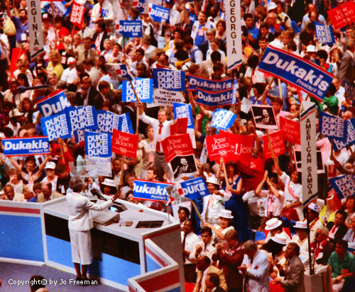 a mixture of Dukakis and Jackson signs in a crowd