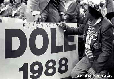 a man writes Elizabeth across the top of a Dole 1988 poster