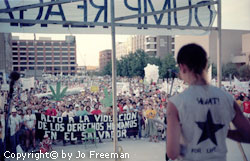 a group of young men carry colorful banners supporting gay rights, one reads pagan gay and loud