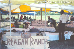 a vew through tent kiosks one has a sign reading Reagan Ranch
